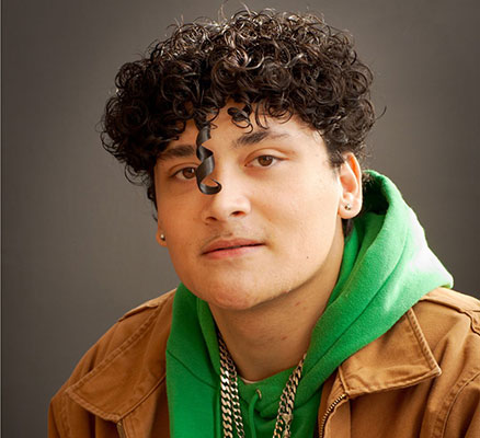 headshot_of_jolly_wrapper_wearing_green_sweatshirt_tan_jacket