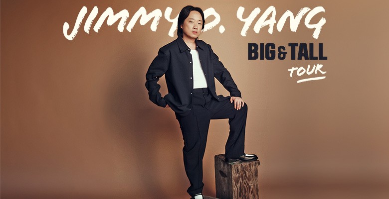 Photo of Jimmy O. Yang standing in pose with one foot standing on a box stool, with hand on hip and hand on knee. Text overlay that reads Jimmy O. Yang Big and Tall Tour