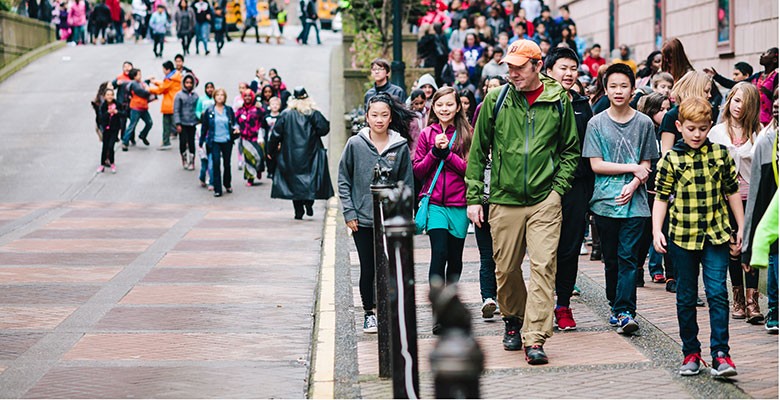 Portland'5 Education & Community Engagement (Photo of students and teach walking outside Arlene Schnitzer Concert Hall to go to s student performance. Photo by Jason Quigley.)