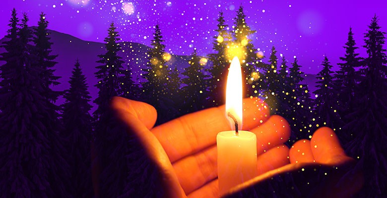 Image of hand holding a burning candle with forest silhouette background and purple sky
