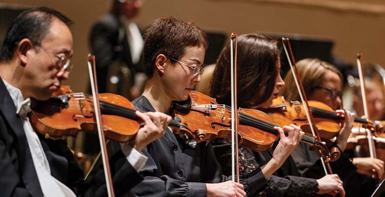 Photo of Oregon Symphony violinists performing