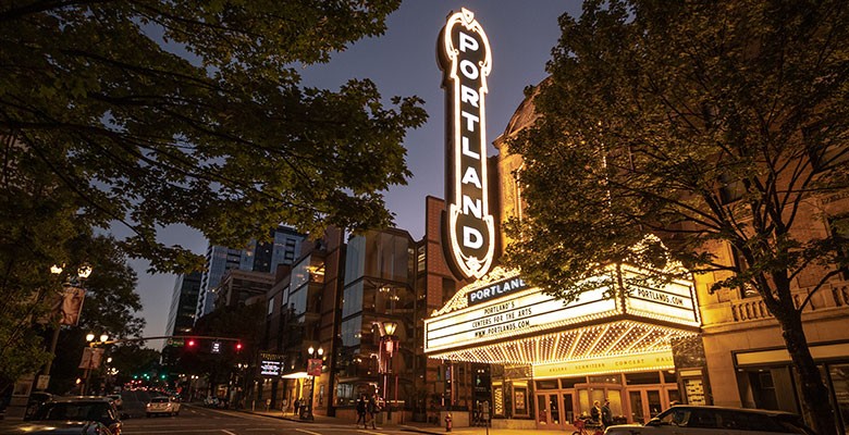 Arlene Schnitzer Concert Hall exterior on Broadway Ave. | Marquee and Portland sign lights at dusk | Photo: Jeremy Jeziorski