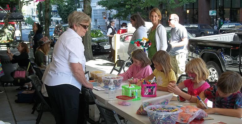 Photo: Children enjoying the kids crafts area at Summer Arts on Main Street.