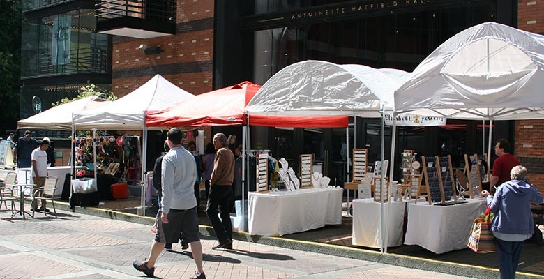 Photo: Vendor booths at Summer Arts on Main Street offering handmade crafts.