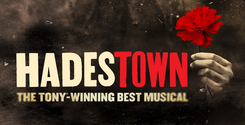 Hadestown title art image with a hand holding a red flower