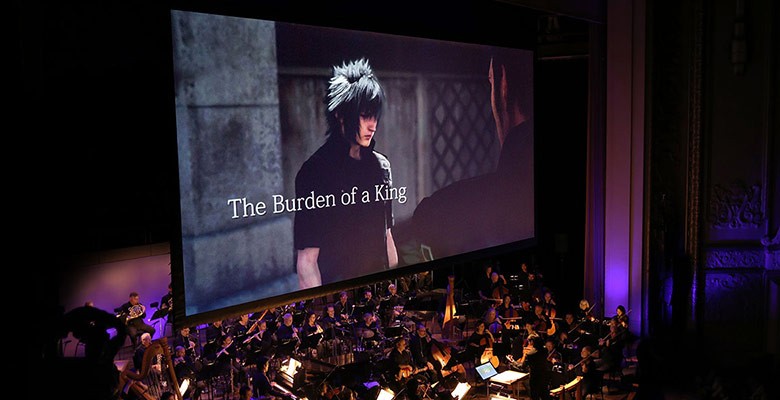 Photo of film screen with scene from Final Fantasy showing & symphony playing