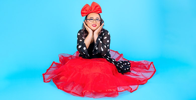 Photo of Robin Tran in a red dress on a blue background