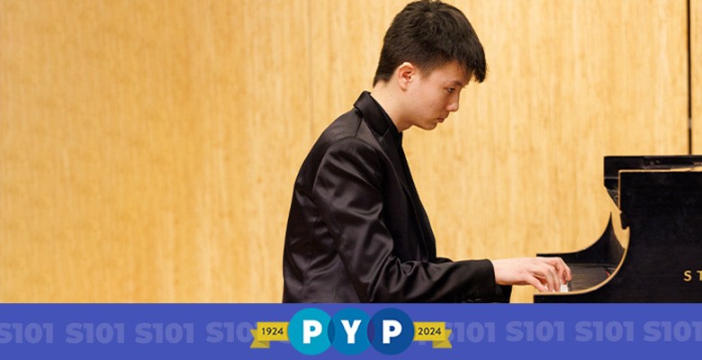 Photo of PYP musician Hansen Barrett sitting at piano playing