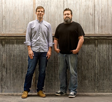 Photo of Josh Clark and Chuck Bryant in front of metal siding.