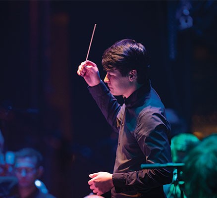 Oregon Symphony | Classical Knockouts image (photo of conductor in action)