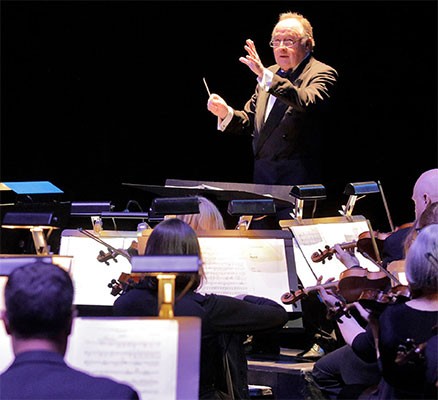 Photo: Maestro George Manahan conducts live orchestra
