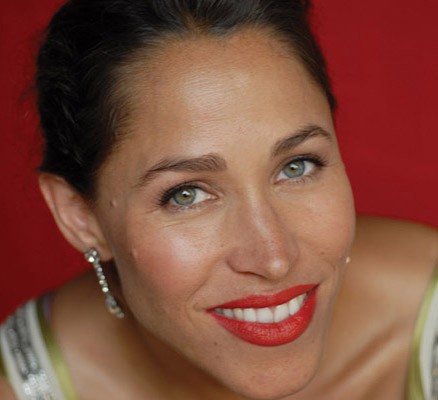 Photo of China Forbes smiling against a red backdrop.