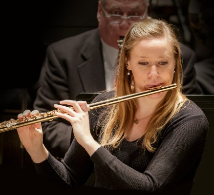 Photo of Martha Long playing flute in concert.