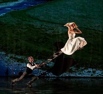 Photo of Momix dancers performing with ladder swing as prop