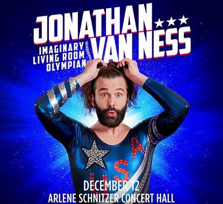 Photo of Jonathan Van Ness wearing a blue gymnist unitard with USA letters on it