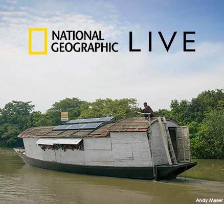 Photo of boat on river with solar panels on roof in Bangladesh
