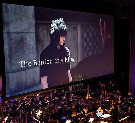 Photo of film screen with scene from Final Fantasy showing & symphony playing