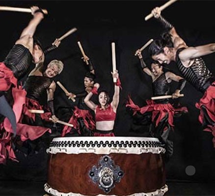 Photo of Drum Tao drummers performing with large drum