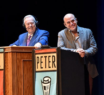 Photo of Bill and Peter from Wait Wait Don't Tell Me standing behind podiums