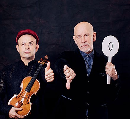 Photo of Aleksey Igudesman holding violin and Malkovich holding a sign with "0"