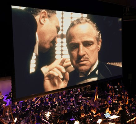 Photo of The Godfather on playing on screen with orchestra playing below