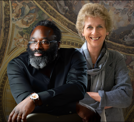 awadagin pratt and Dame jane glover standing next to eachother in front of an ornate gold backdrop