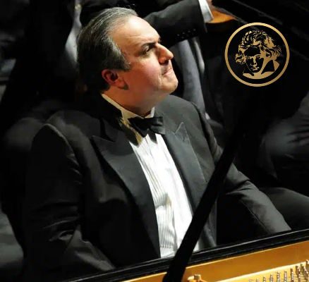 yefim bronfman in tuxedo at piano playing and looking to right