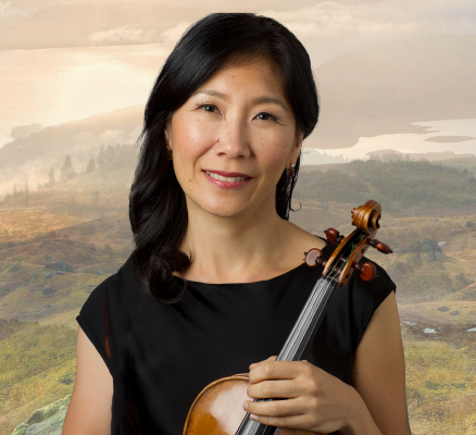 sarah kwak holding violin in front of mountainside backdrop