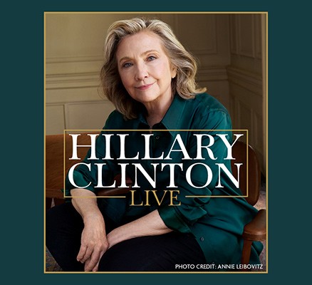 Photo by Annie Leibovitz of Hillary Clinton seated in chair, smiling + title tex