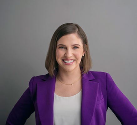 photo of lindsay chervinsky smiling in a purple blazer and white shirt