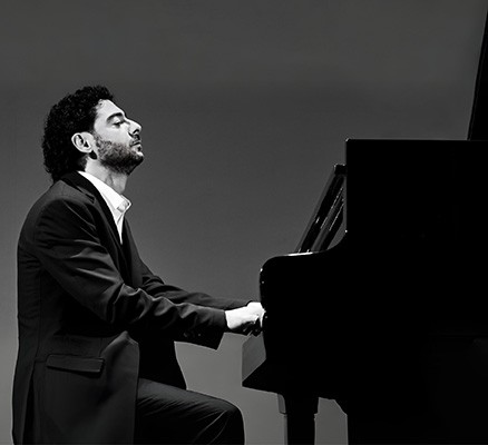 Photo of Artur Zakiyan sitting at and playing piano