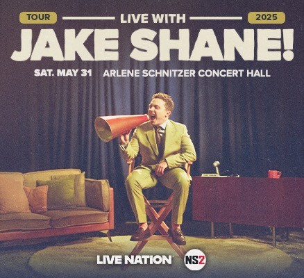 Photo of Jake Shane sitting in director's chair with megaphone + tour title text