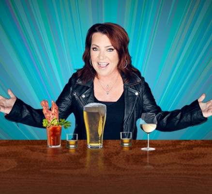 Photo of Kathleen Madigan standing at table with drinks on it