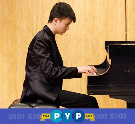 Photo of PYP musician Hansen Barrett sitting at piano playing