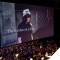Photo of film screen with scene from Final Fantasy showing & symphony playing