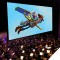 Photo of Toy Story scene (Woody and Buzz) being shown on screen with symphony