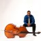 Photo of Xavier Foley sitting with double bass laying in front of him