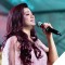 Photo of Shreya Ghosal singing holding microphone