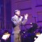 Photo of John Cameron Mitchell singing with orchestra on stage