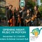 Photo of MYS conductor and musicians standing on street with "Portland" sign