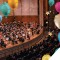 Photo of Oregon Symphony on stage at Schnitzer Hall with balloons in air