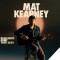 singer songwriter matt kearney on stool in front of name with black background