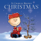 illustration of charlie brown in snow holding ornament next to small bare christmas tree