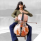 woman playing cello in front of grey backdrop of indigenous people in front of waterfalls