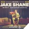 Photo of Jake Shane sitting in director's chair with megaphone + tour title text