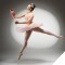 Photo of ballerina in pose, holding a nutcracker toy